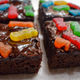 Close-up of Sour Patch Kids Brownies with chocolate ganache and candy on top